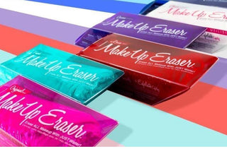 Five colorful Makeup Erasers lying across a rainbow background. 